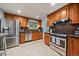 Modern kitchen featuring stainless steel appliances, wooden cabinets and tile floors at 8364 Allison Ct, Arvada, CO 80005