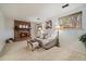 A cozy living room showcasing a brick fireplace, neutral furniture, and two bright windows at 8364 Allison Ct, Arvada, CO 80005