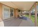 A covered patio featuring comfortable seating and outdoor lighting overlooking the backyard at 8364 Allison Ct, Arvada, CO 80005