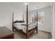 Well-lit bedroom with a four-poster bed and view to the outside at 3601 E 103Rd Cir # B11, Thornton, CO 80229