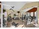 Well-equipped home gym with mirrored wall, weight machines, treadmill, and stationary bike at 3601 E 103Rd Cir # B11, Thornton, CO 80229