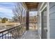 Private balcony with black metal railing, brick support beam, and sliding glass doors at 3601 E 103Rd Cir # B11, Thornton, CO 80229