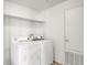 Bright laundry room featuring white washer and dryer, shelf, and utility door at 3601 E 103Rd Cir # B11, Thornton, CO 80229