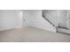 Spacious basement area with neutral carpet and access to stairs at 12780 Elm St, Thornton, CO 80241