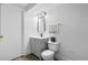 Clean bathroom with modern vanity, toilet, and a frameless mirror at 12780 Elm St, Thornton, CO 80241