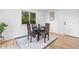Cozy dining area featuring a round table, chairs, and natural light from a large window at 12780 Elm St, Thornton, CO 80241
