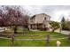 Charming two-story home featuring a well-maintained lawn and a welcoming front porch with stylish columns at 12780 Elm St, Thornton, CO 80241