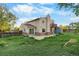 Back exterior view of a two-story home with a patio and a fenced yard at 12780 Elm St, Thornton, CO 80241