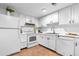 Well-lit kitchen with white cabinetry, stainless steel appliances, and efficient use of space at 12780 Elm St, Thornton, CO 80241