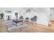 Spacious living area with modern furniture, hardwood floors, and ample natural light from large windows at 12780 Elm St, Thornton, CO 80241