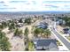 Scenic aerial view of a community with winding roads, lush trees, and mountain views in the distance at 23742 E Calhoun Ave, Aurora, CO 80016