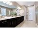 Bathroom featuring double sink vanity with black cabinetry, tile floors and a walk-in shower at 23742 E Calhoun Ave, Aurora, CO 80016