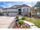 Beautiful two-story home featuring stone accents, manicured landscaping, and a spacious driveway at 23742 E Calhoun Ave, Aurora, CO 80016