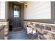 Inviting covered front porch with a decorative bench and stone accents at 23742 E Calhoun Ave, Aurora, CO 80016