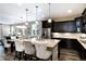 Open kitchen featuring dark cabinets, an island with seating, and stainless steel appliances at 23742 E Calhoun Ave, Aurora, CO 80016