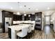 Stylish kitchen with dark cabinetry, stainless steel appliances, and an island with seating at 23742 E Calhoun Ave, Aurora, CO 80016
