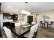 Gourmet kitchen with dark cabinets, stainless appliances, a large island with barstool seating, and dining area at 23742 E Calhoun Ave, Aurora, CO 80016