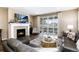 Cozy living room with fireplace, large glass doors to the outside, hardwood flooring, and neutral color palette at 23742 E Calhoun Ave, Aurora, CO 80016
