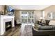 Inviting living room featuring a fireplace, sliding glass doors, hardwood floors, and comfortable seating at 23742 E Calhoun Ave, Aurora, CO 80016