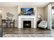 Cozy living room area featuring a fireplace, hardwood floors, and a comfortable sitting area with natural light at 23742 E Calhoun Ave, Aurora, CO 80016