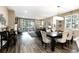 Open floor plan featuring fireplace, large glass sliding doors, neutral tones, and dining space with modern chandelier at 23742 E Calhoun Ave, Aurora, CO 80016