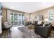 Bright living room features fireplace, neutral tones, large windows, and sliding doors to outdoor balcony at 23742 E Calhoun Ave, Aurora, CO 80016