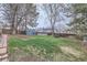 Large backyard with mature trees, a shed, and a wooden fence providing privacy at 9902 Independence St, Broomfield, CO 80021