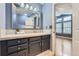 Updated bathroom featuring a vanity with stone countertop, and ample lighting at 9902 Independence St, Broomfield, CO 80021