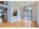 Elegant dining area with hardwood floors, a chandelier, and sliding doors to a deck or patio at 9902 Independence St, Broomfield, CO 80021