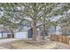 Inviting two-story home with a brick and blue exterior, mature trees, and a well-manicured front lawn at 9902 Independence St, Broomfield, CO 80021
