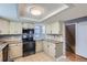 Modern kitchen featuring updated appliances, granite countertops, and stylish cabinetry for storage at 9902 Independence St, Broomfield, CO 80021