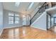 Bright and airy living room featuring hardwood floors, a staircase with black railings, and skylights at 9902 Independence St, Broomfield, CO 80021