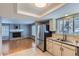 Open-concept kitchen flowing into a living area with a brick fireplace and hardwood floors, perfect for entertaining at 9902 Independence St, Broomfield, CO 80021
