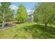 Spacious backyard features mature trees and a wood fence at 3745 Balderas St, Brighton, CO 80601