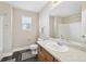 Bathroom with a single sink, large mirror, wood cabinet, toilet and shower with tub at 3745 Balderas St, Brighton, CO 80601