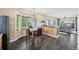 Cozy dining area featuring a bay window, hardwood floors, and a view into the living room at 3745 Balderas St, Brighton, CO 80601