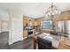 Bright eat-in kitchen features stainless appliances, wood cabinets, and modern lighting fixture at 3745 Balderas St, Brighton, CO 80601