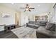 Open-concept living space with a large sectional sofa flowing seamlessly into the dining area at 3745 Balderas St, Brighton, CO 80601