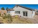 Backyard featuring a small deck with seating, sliding glass doors, and low-maintenance landscaping at 3309 Thornwood Ct, Castle Rock, CO 80108