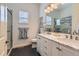 Elegant bathroom featuring double sinks with marble countertops, sleek white cabinetry, and a glass-enclosed shower at 3309 Thornwood Ct, Castle Rock, CO 80108