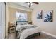 Cozy bedroom featuring a comfortable bed with green accents, soft lighting, and stylish tropical wall decor at 3309 Thornwood Ct, Castle Rock, CO 80108