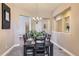 Formal dining room with elegant chandelier, spacious layout, and pass-through to kitchen at 3309 Thornwood Ct, Castle Rock, CO 80108