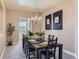 Elegant dining room featuring a large table set for eight, a chandelier, and neutral decor at 3309 Thornwood Ct, Castle Rock, CO 80108