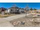 Lovely two-story home featuring a long driveway and beautiful landscaping along the front at 3309 Thornwood Ct, Castle Rock, CO 80108