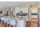 Modern kitchen with granite countertops, stainless steel appliances, island seating, and a view into the living area at 3309 Thornwood Ct, Castle Rock, CO 80108