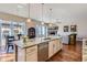 Open-concept kitchen flowing into a dining and living area with a cozy fireplace and large windows for natural light at 3309 Thornwood Ct, Castle Rock, CO 80108