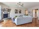 Spacious living room with a fireplace, ceiling fan, and comfortable gray sofa, perfect for relaxing at 3309 Thornwood Ct, Castle Rock, CO 80108