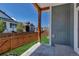 Back porch with wooden support posts overlooks grassy yard with wood fence and neighboring homes at 11494 Colony Loop, Parker, CO 80138