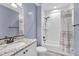 Cozy bathroom featuring a shower over tub, granite-topped vanity, and neutral wall color at 11494 Colony Loop, Parker, CO 80138