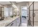 Stylish bathroom featuring a double vanity and shower with glass enclosure, bedroom view at 11494 Colony Loop, Parker, CO 80138